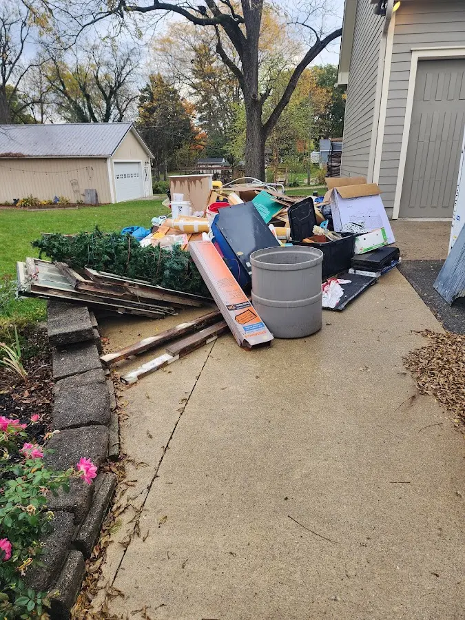 Dumpster being loaded with debris for 12 Yard Dumpster Rental in Pittsfield